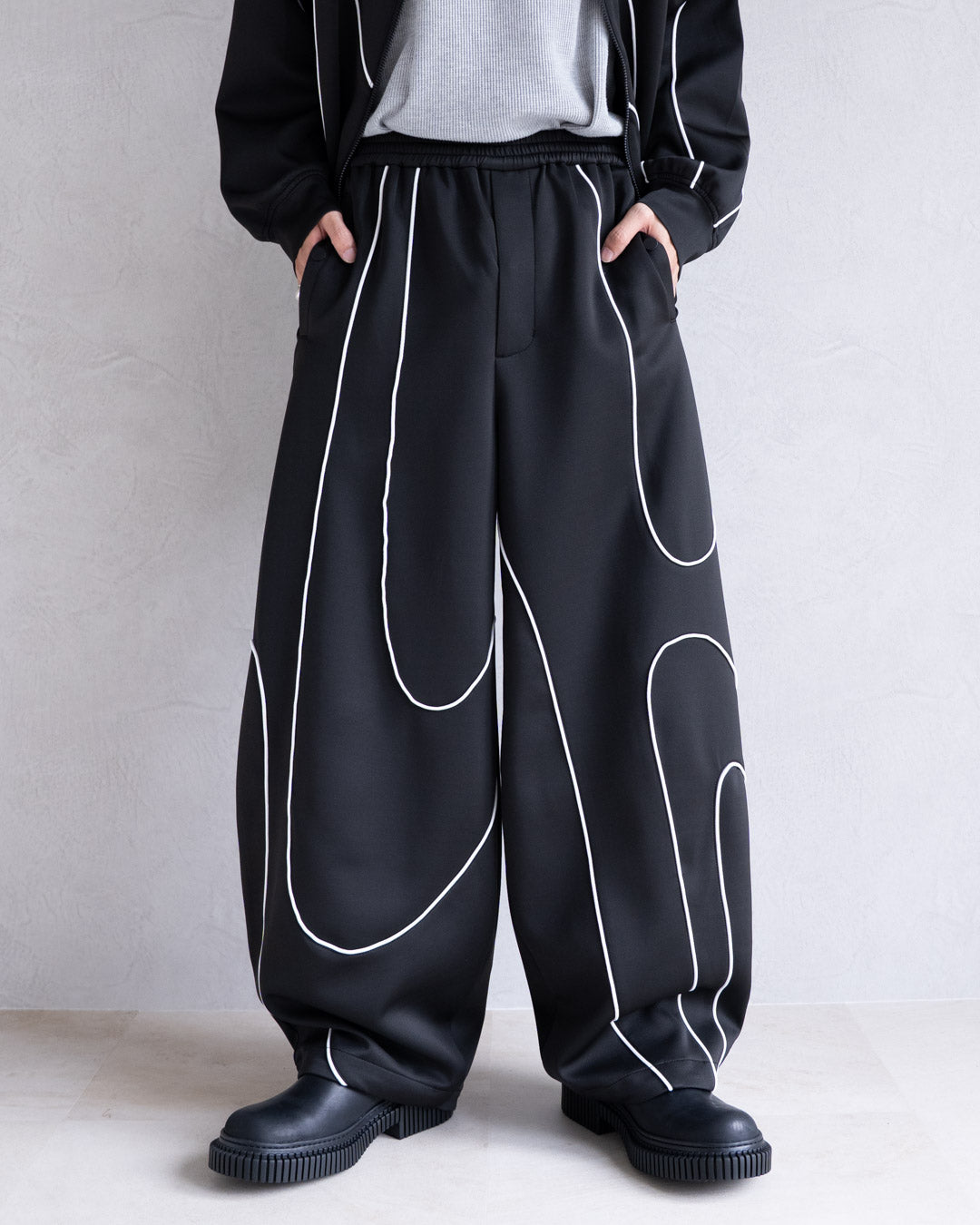 DISTORT PIPING TRACK PANTS
